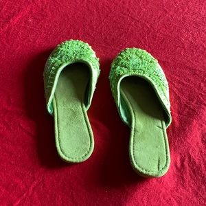 Lime Green sleepers with oriental features on top of slippers